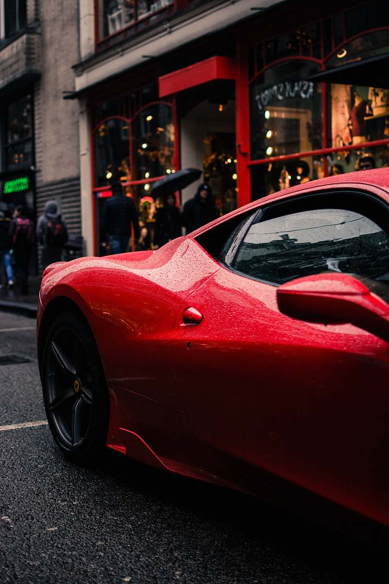 sports car red car beside sidewalk vehicle